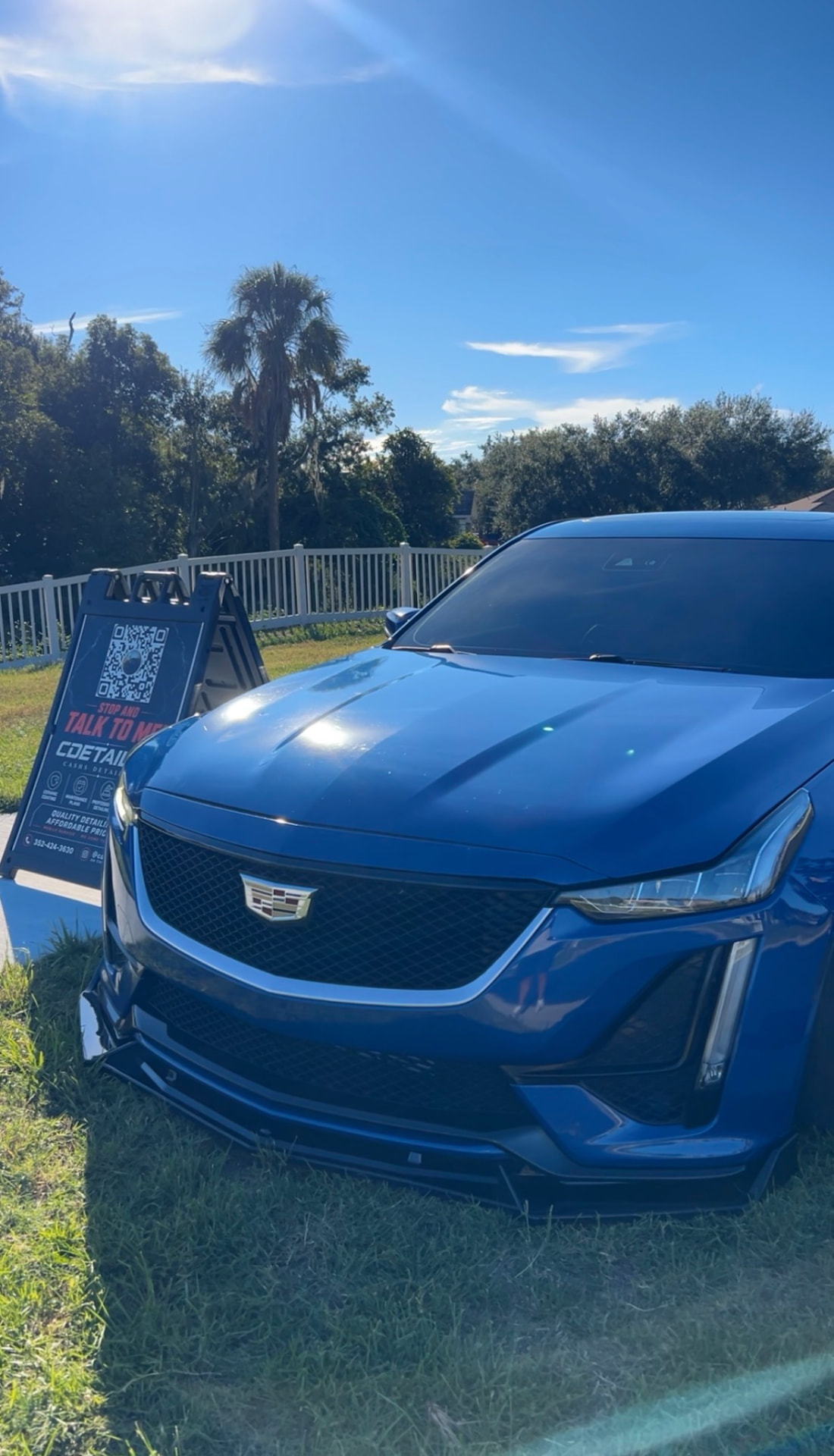 Blue Cadillac sedan with a freshly detailed front end and clean grille