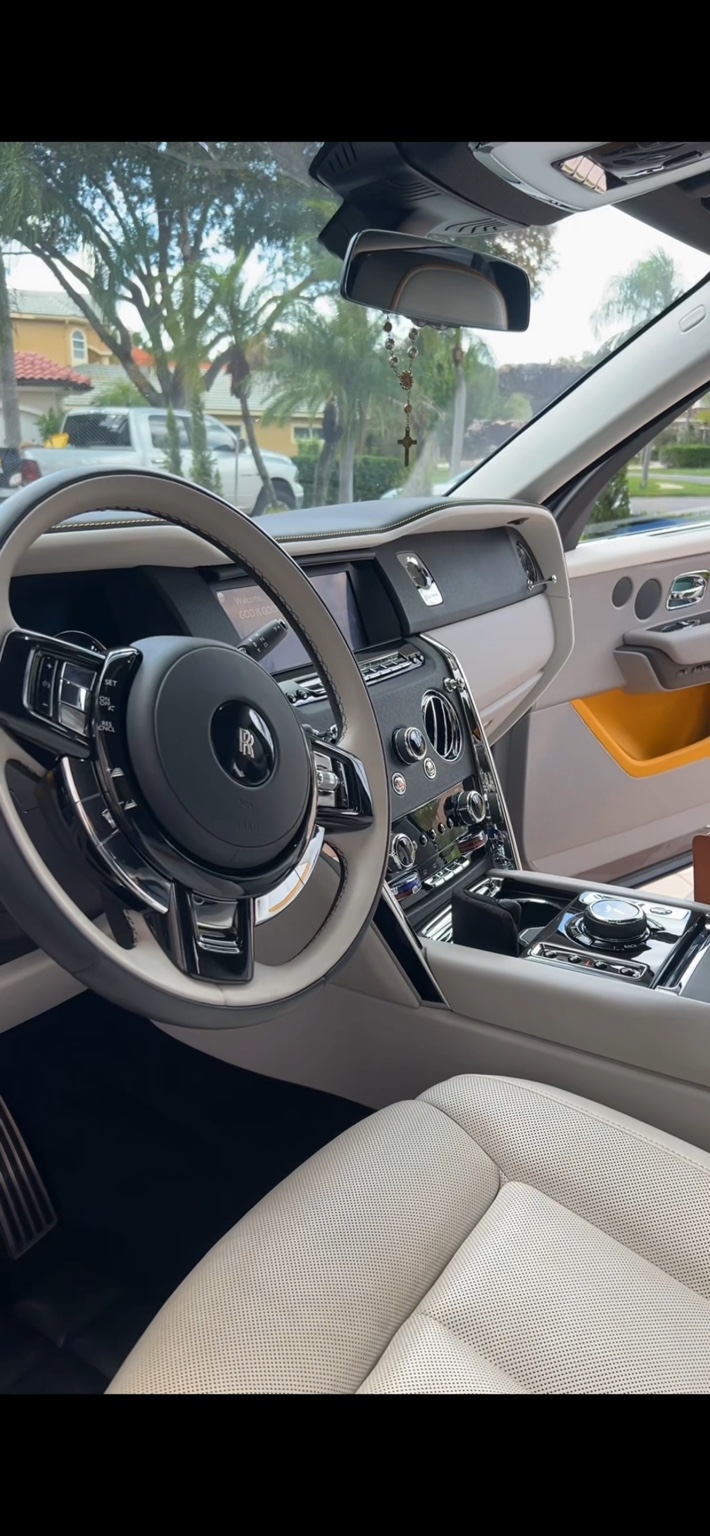 Rolls-Royce interior with pristine cream leather seats and polished console