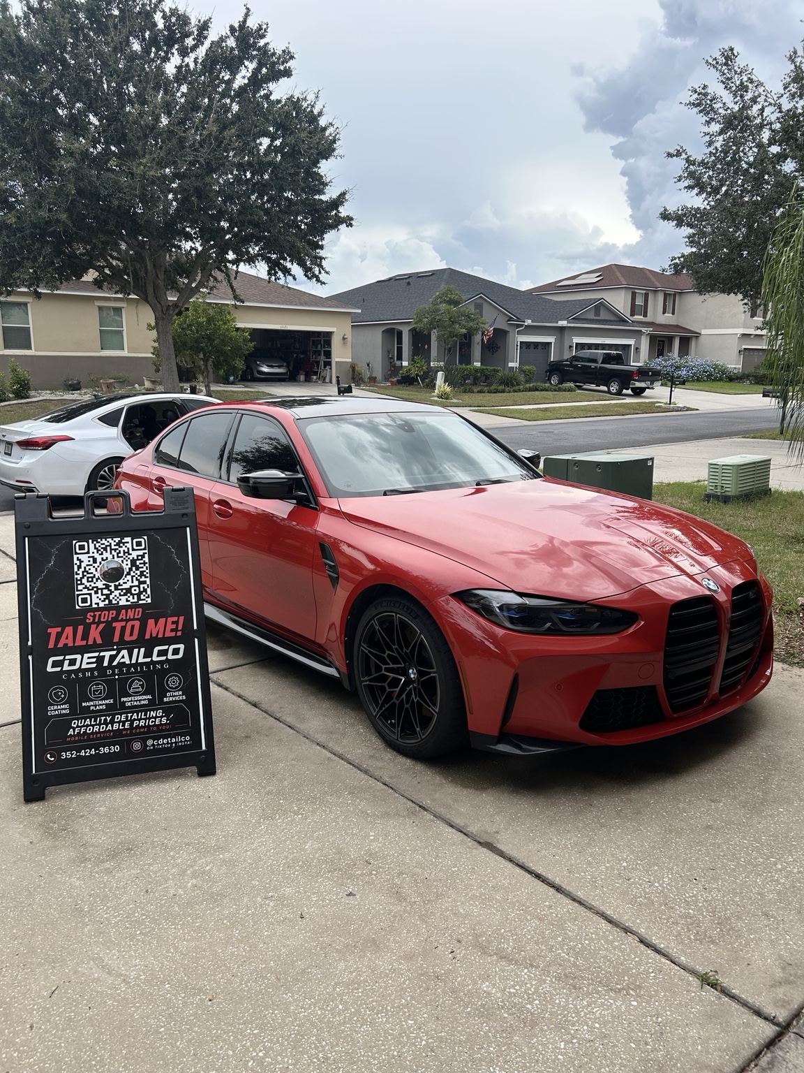 Red BMW M3 sedan with a glossy exterior detail and clean black wheels