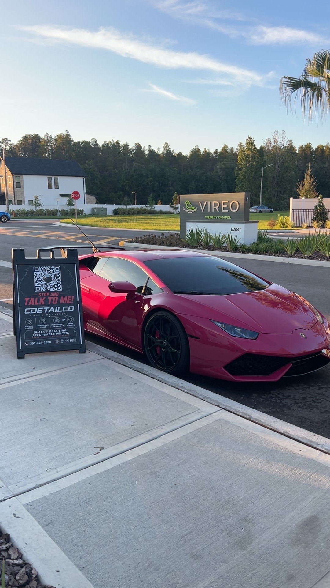 Magenta Lamborghini Huracán with a reflective exterior finish and gloss black wheels